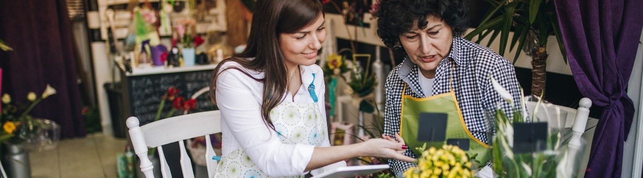 Floral shop owner training her successor