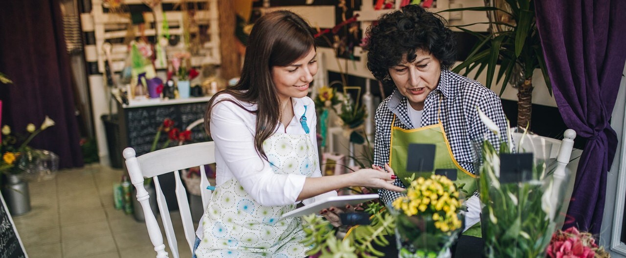 Floral shop owner training her successor