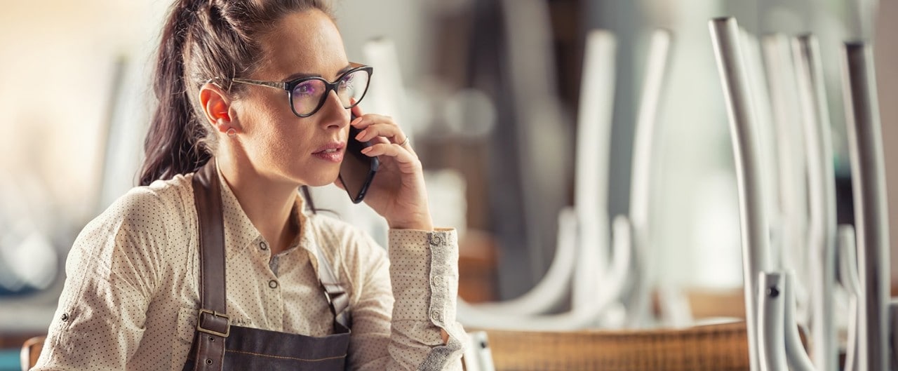 Worried restaurant owner talking on phone