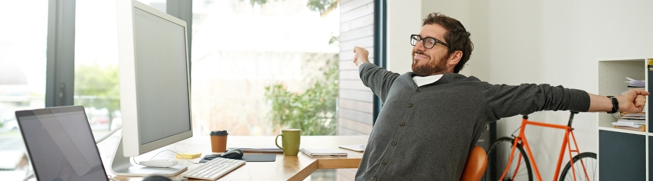 Business owner stretching at desk