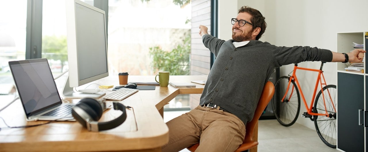 Business owner stretching at desk