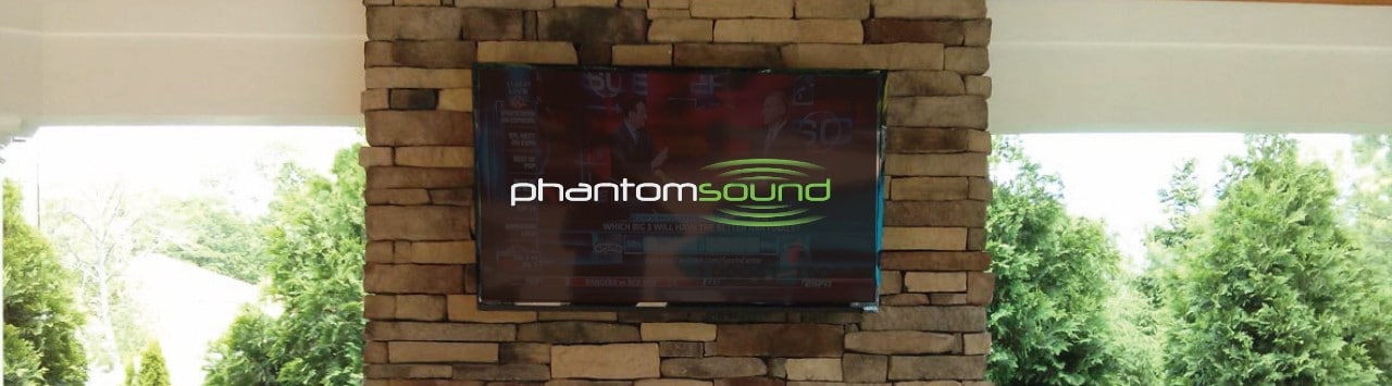 Television hung on a stone mantle displaying Phantom Sound logo