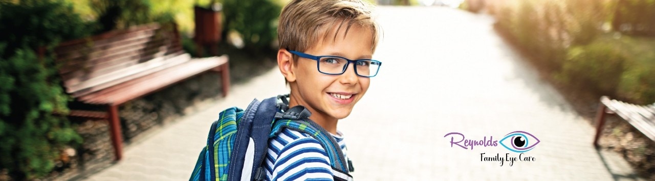 Young boy wearing glasses with superimposed Reynolds Family Eye Care logo