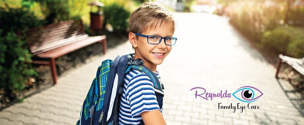 Young boy wearing glasses with superimposed Reynolds Family Eye Care logo