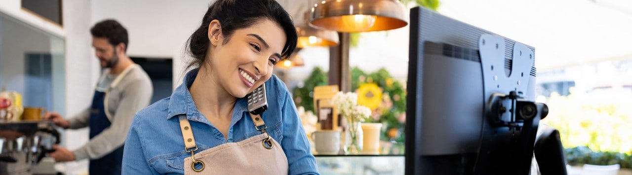 Female coffee shop owner taking order over the phone