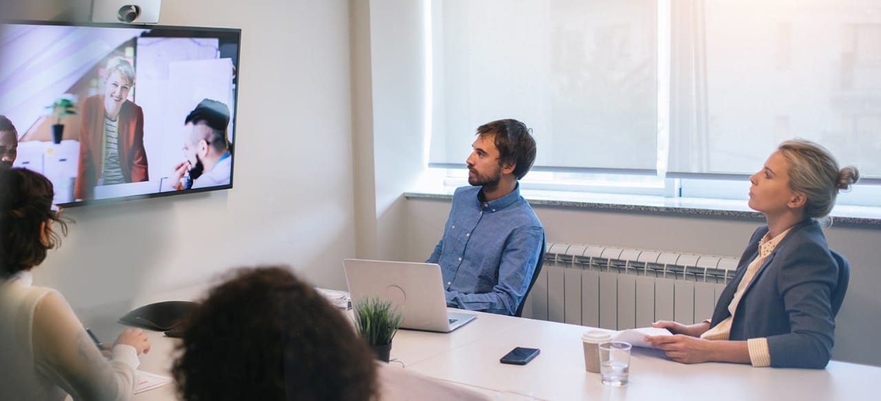 Group of young business people discussing with colleagues on video conference on meeting.