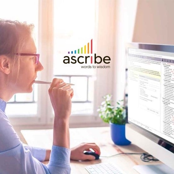 Woman seated at computer, with superimposed Ascribe logo