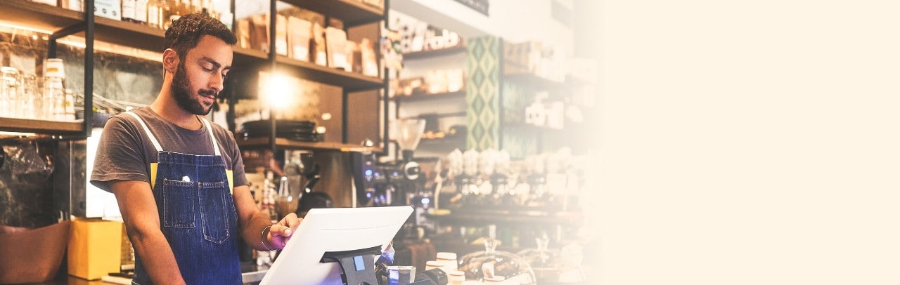 Man in a cafe at touch screen device