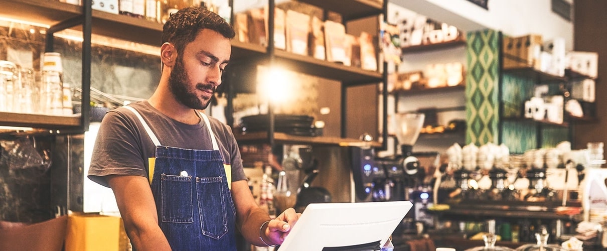 Man in a cafe at touch screen device