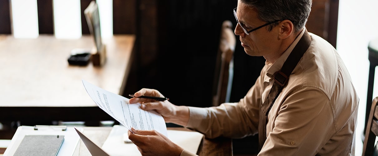 small business owner analyzing reports while working on paperwork in a pub.