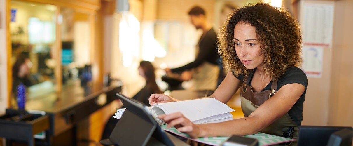 hair salon owner using digital book keeping system