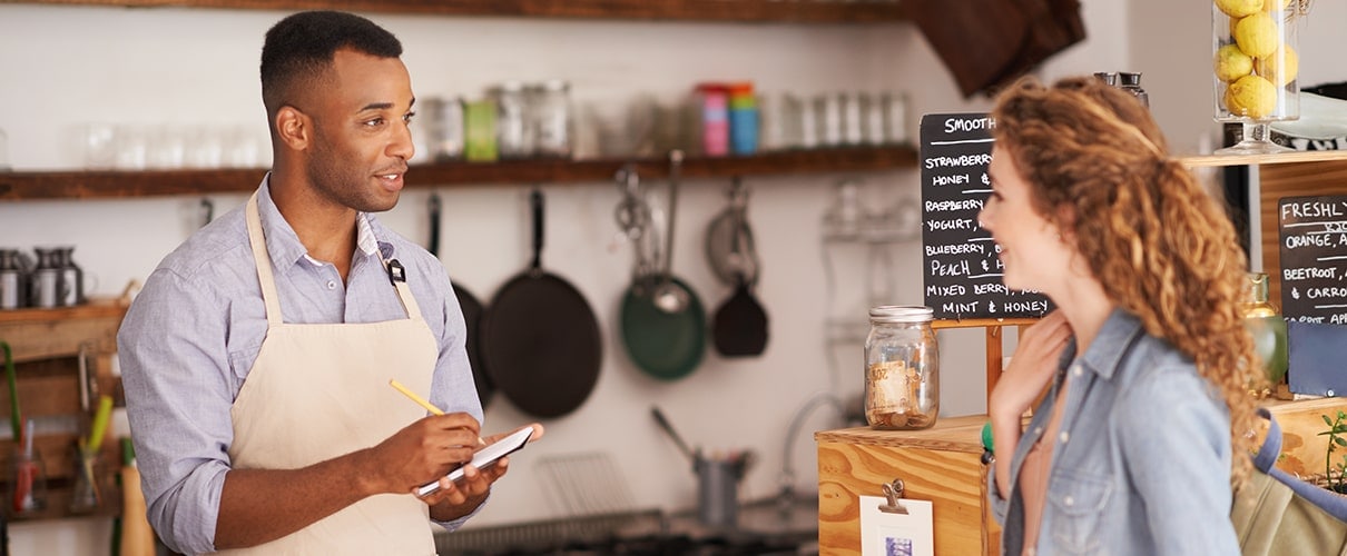 Cropped shot of an attractive young woman placing an order at a coffee shop