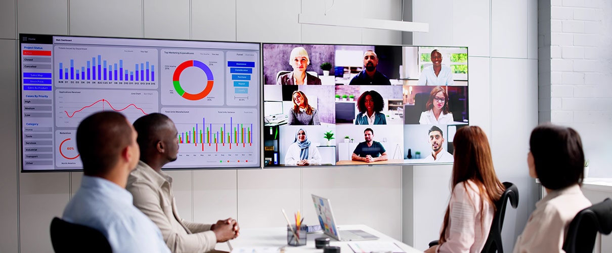 Businesspeople attending a video conference and hybrid presentation with international colleagues