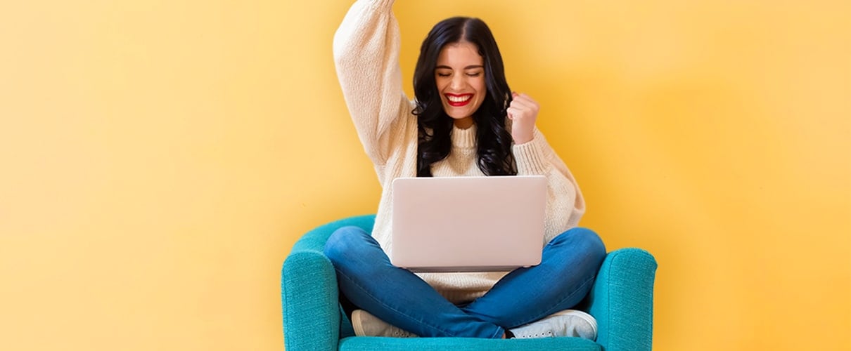 Excited woman on computer