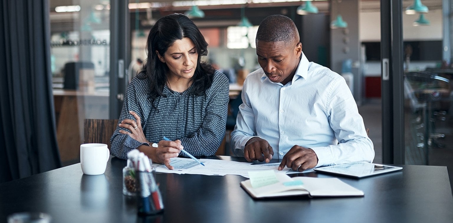 Business associates reviewing documents in conference room