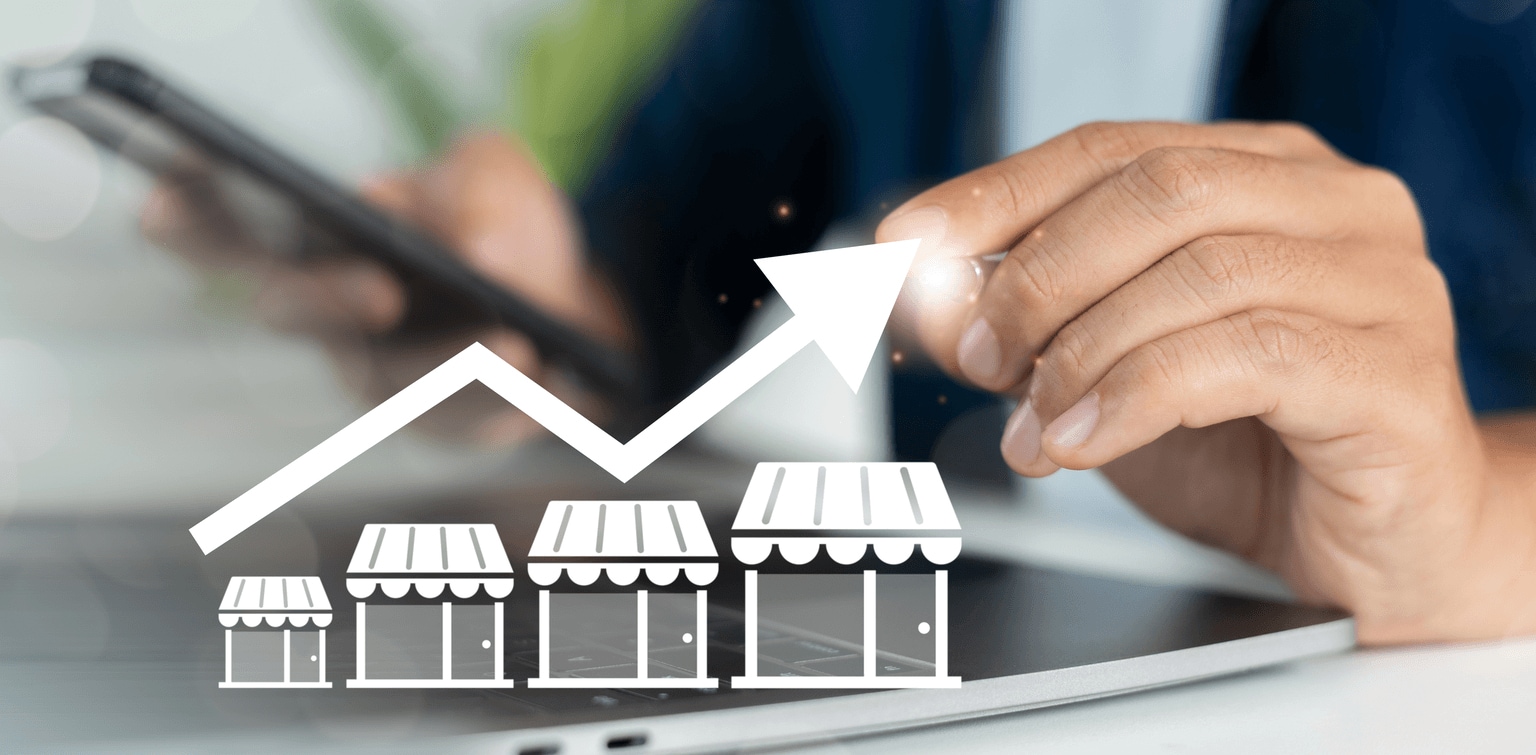 business owner points to a graphic showing business growth