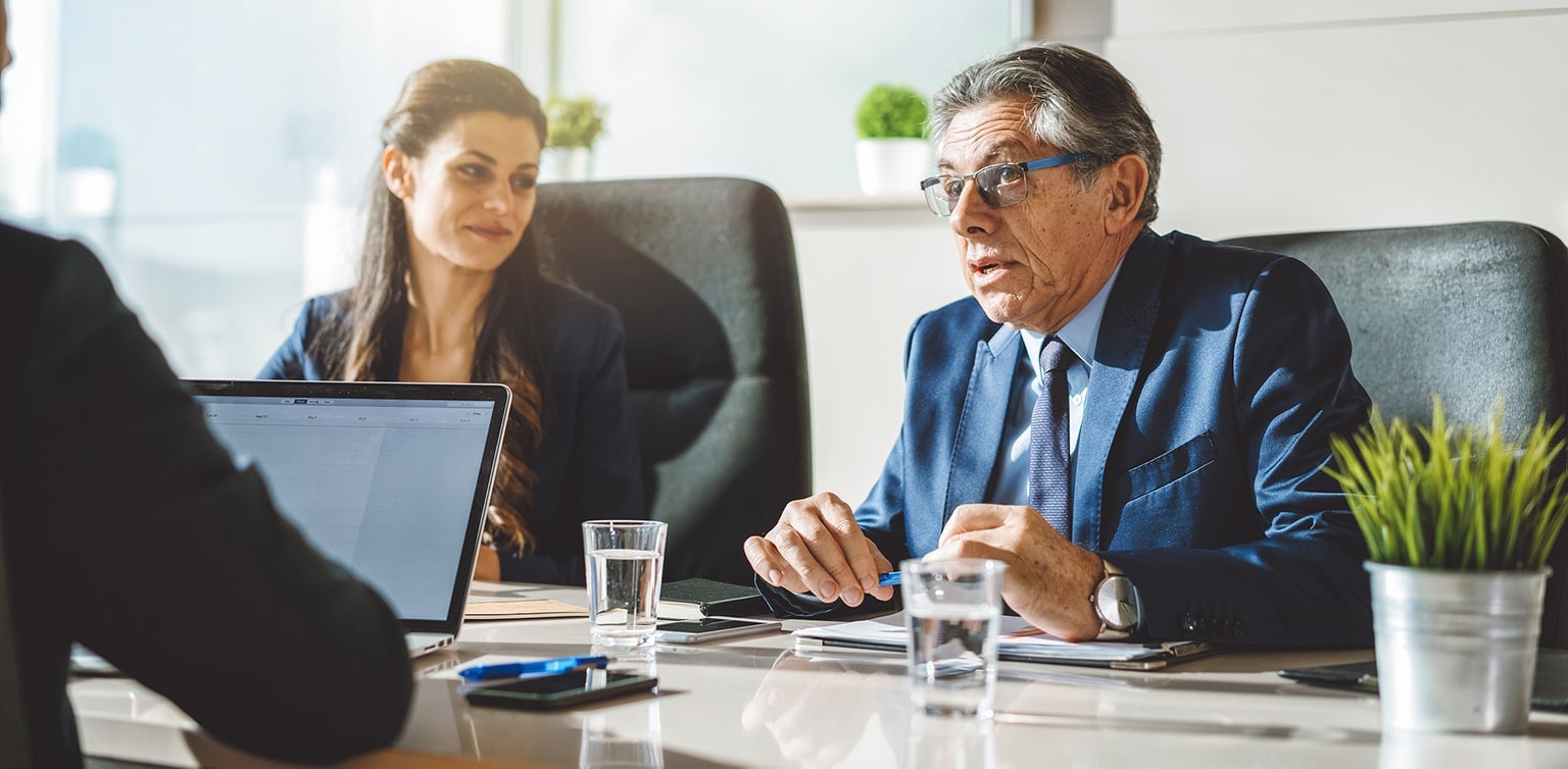 Business colleagues conversing at a conference table