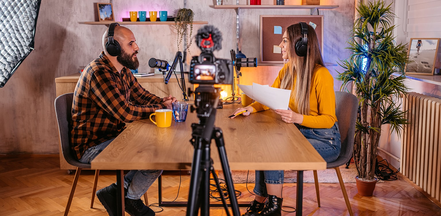 Business owner sitting at table participating in podcast