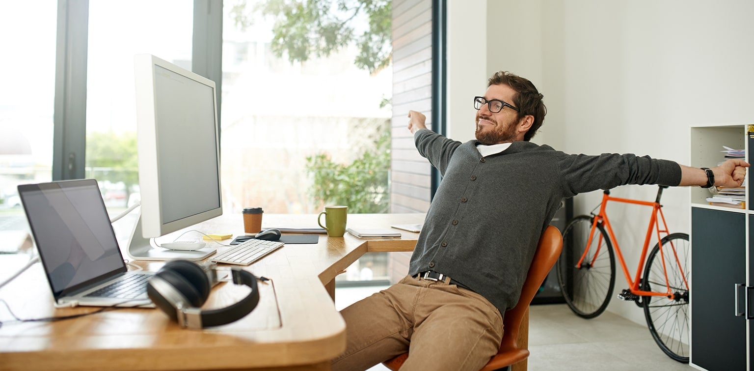 Business owner stretching at desk
