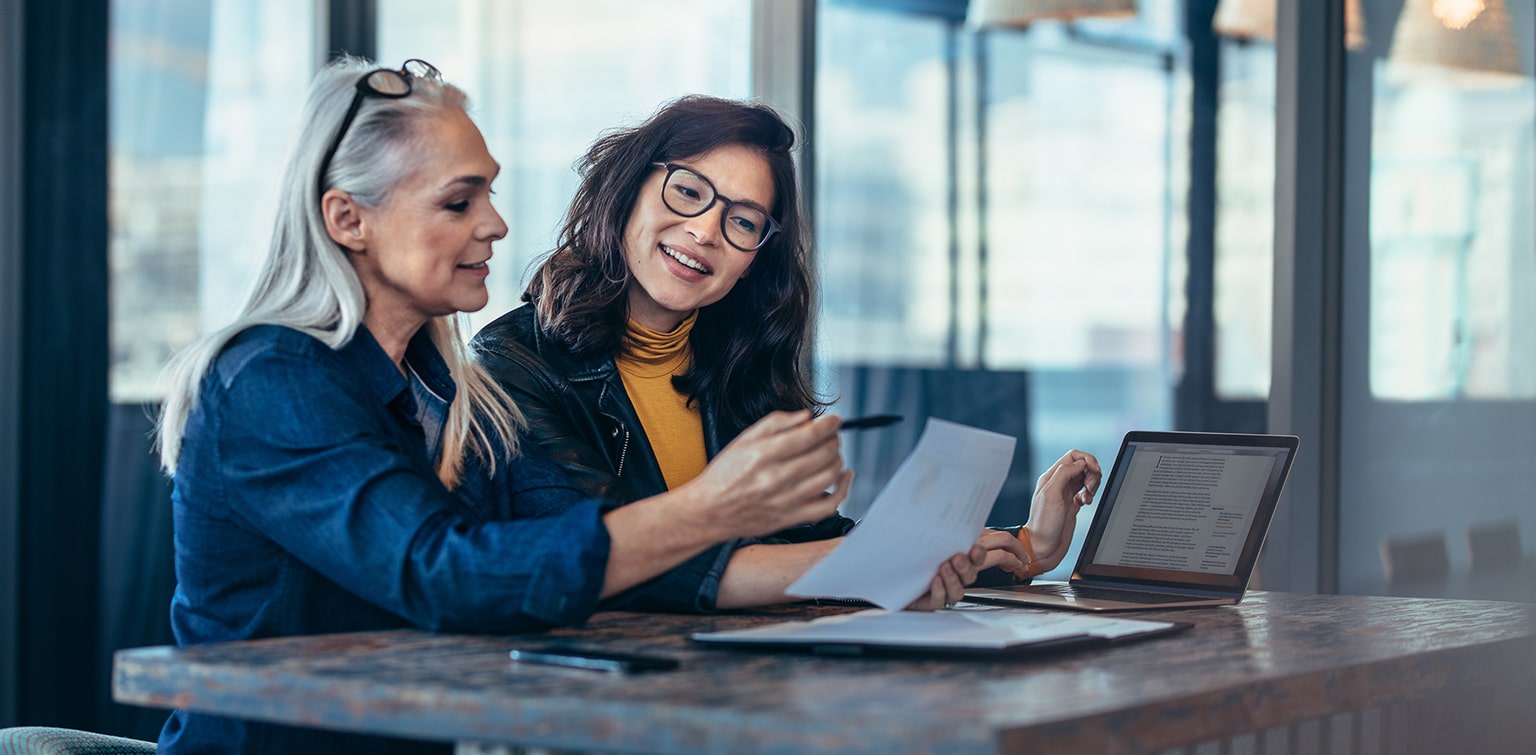 Woman business owner reviewing finances with her successor