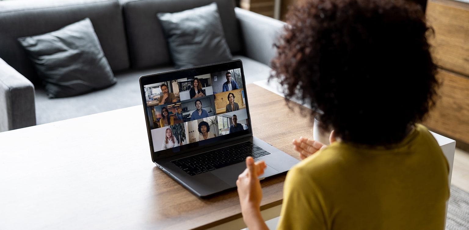 Female small business owner conducting video conference with employees