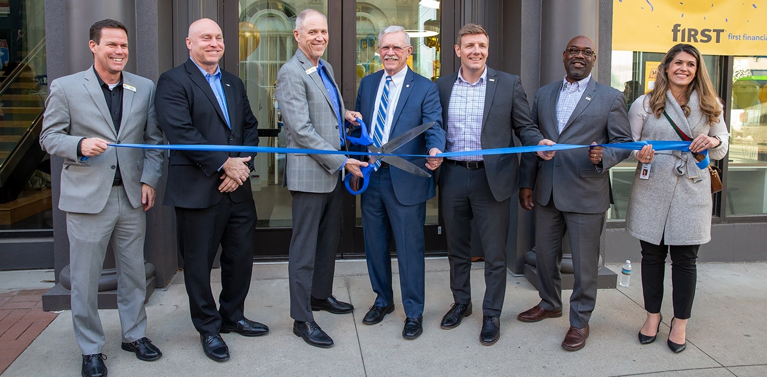 First Financial Bank executives and Covington officials participating in 6th & Madison ribbon-cutting