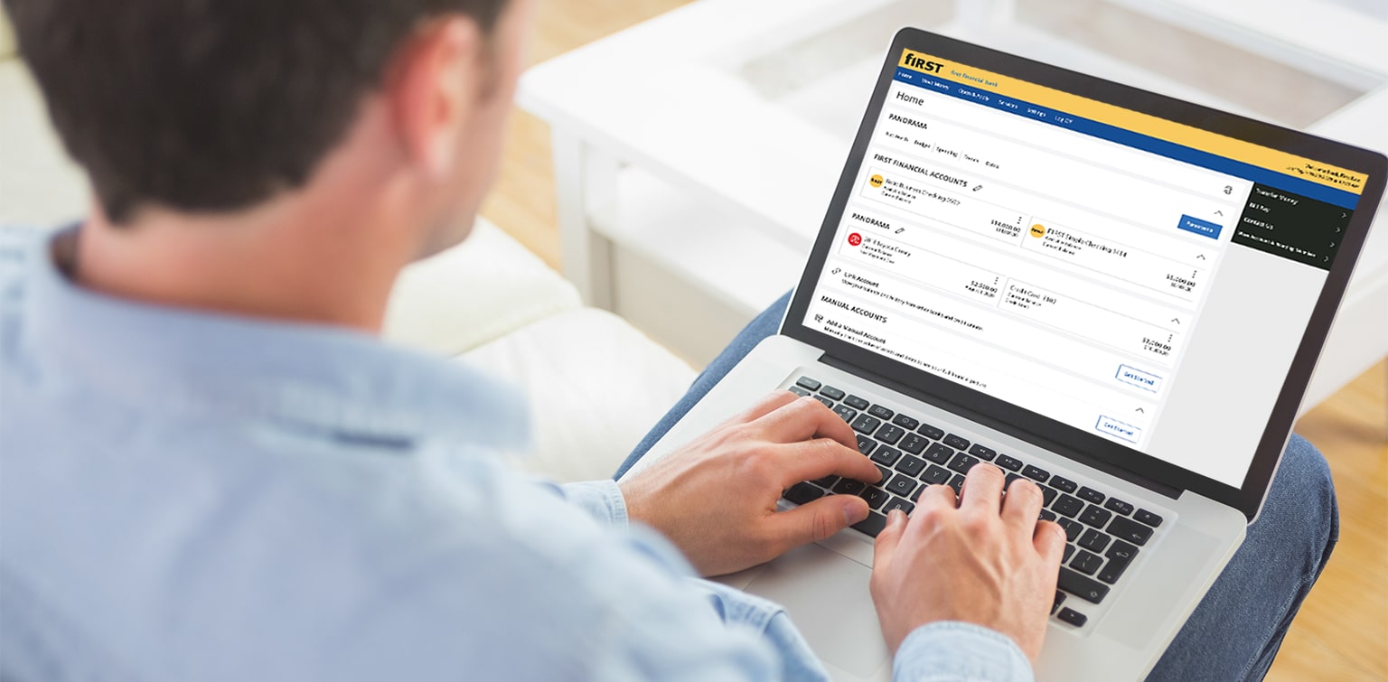 Man looking at First Financial banking accounts on laptop