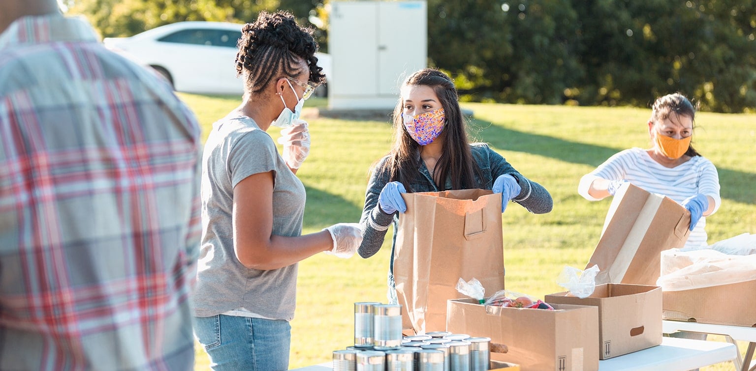 Volunteers wearing masks working at food distribution center