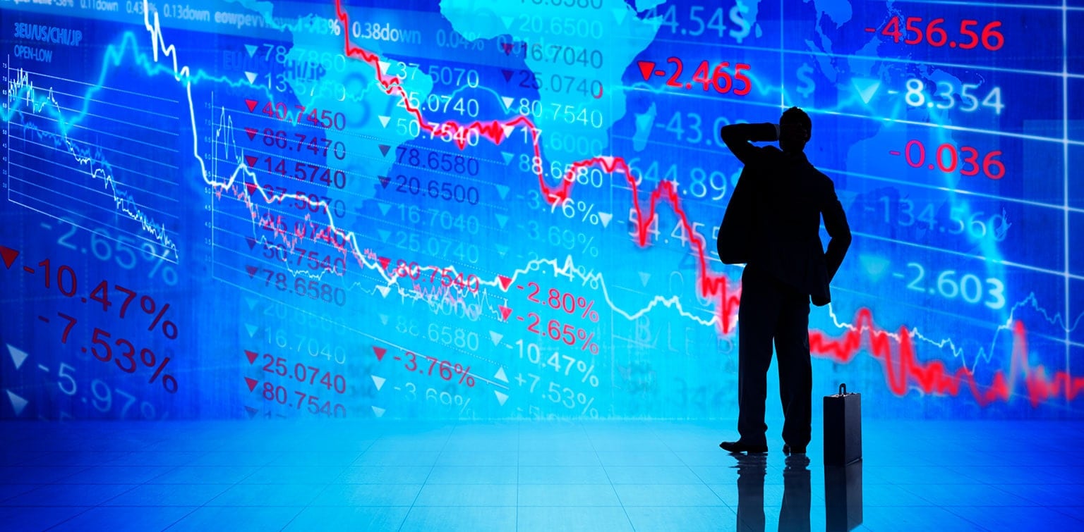 Silhouette of a man with stock market data in the background, suggesting market uncertainty
