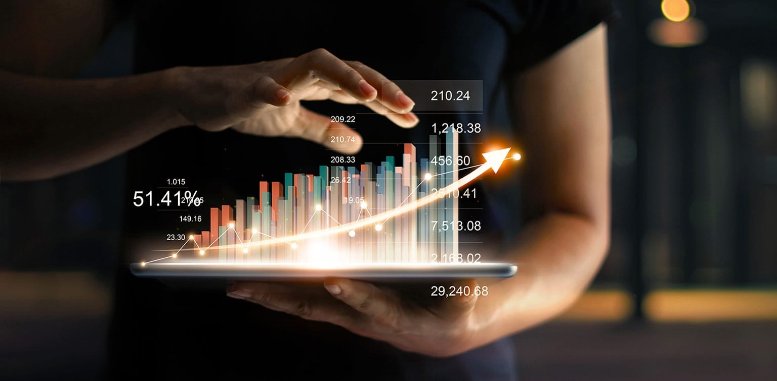 Person holding tablet showing virtual hologram of statistics, graph and chart with arrow up on dark background