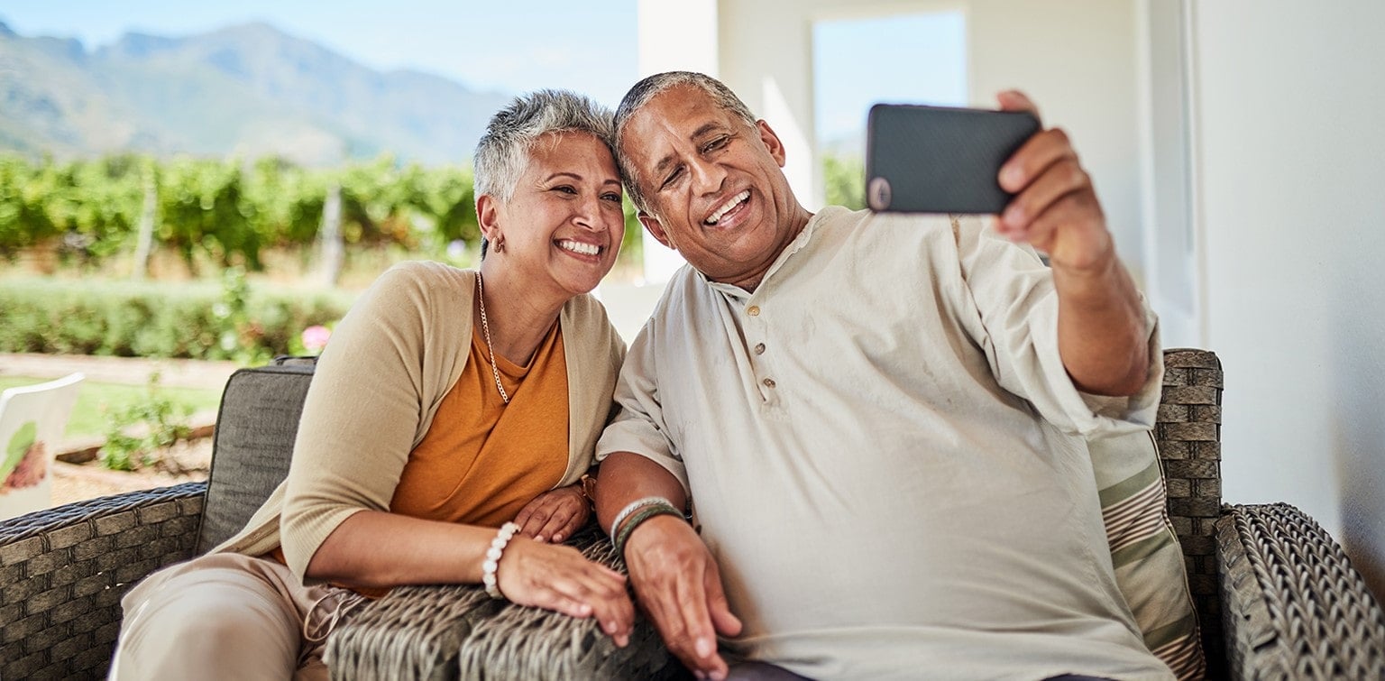 Smiling senior couple taking a selfie