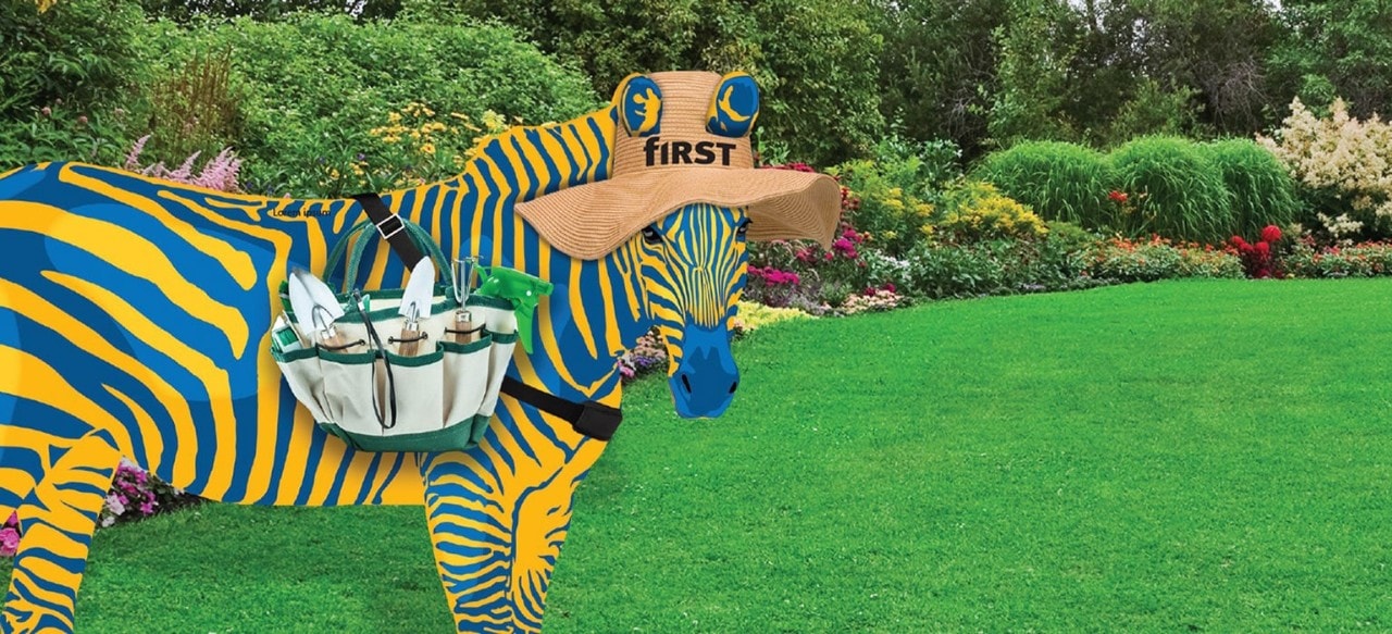 Blue and yellow zebra with straw hat and gardening tools