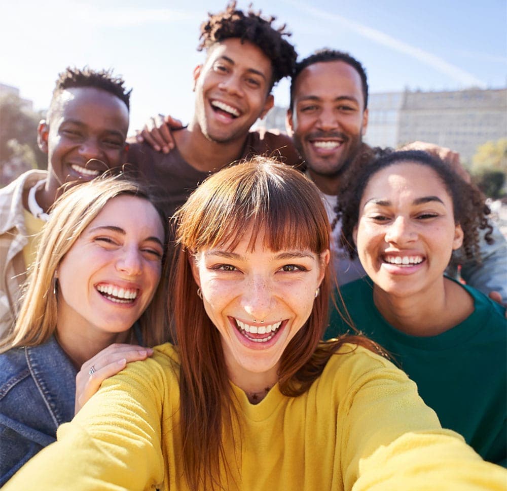 Diverse group of six friends taking a selfie