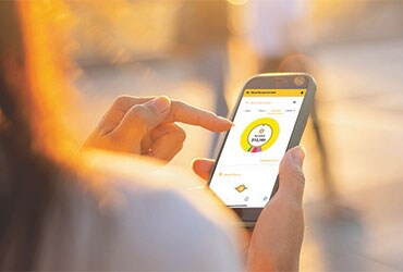 Woman accessing First Financial Bank mobile app on smartphone