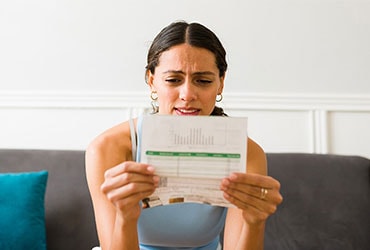 Concerned woman looking at credit card bill