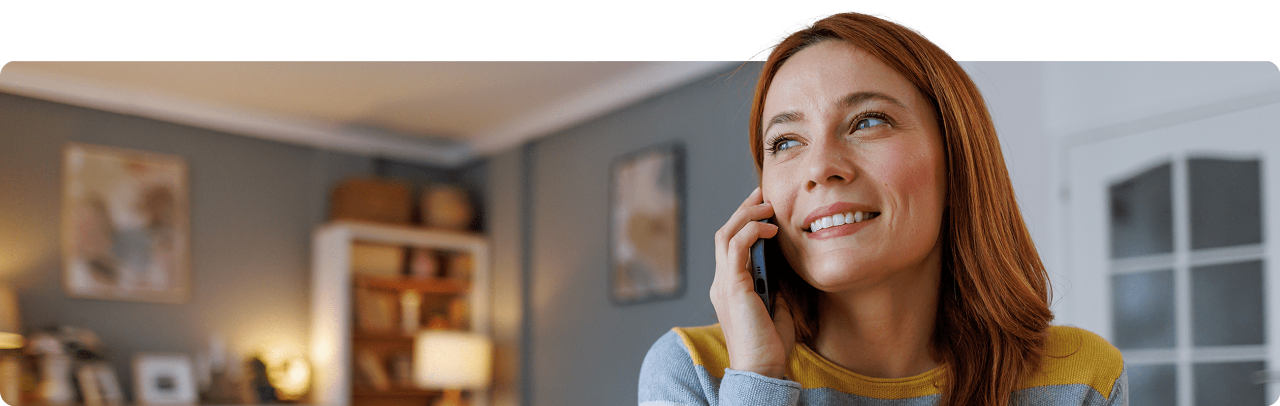 A woman engaged in a phone conversation in her cozy living room