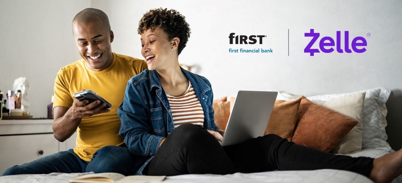 First Financial Bank and Zelle® logos over an image of young couple using laptop and smartphone