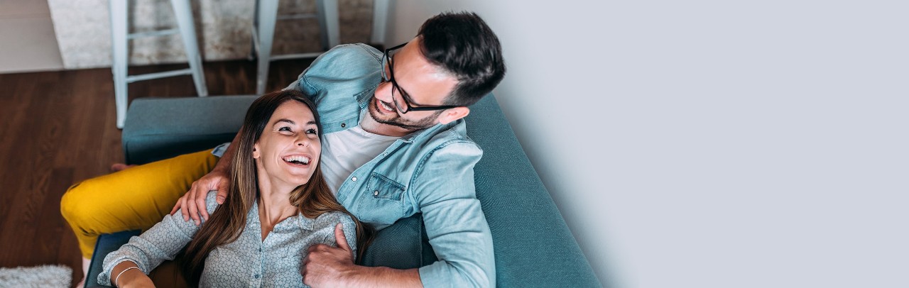 Happy couple sitting on couch