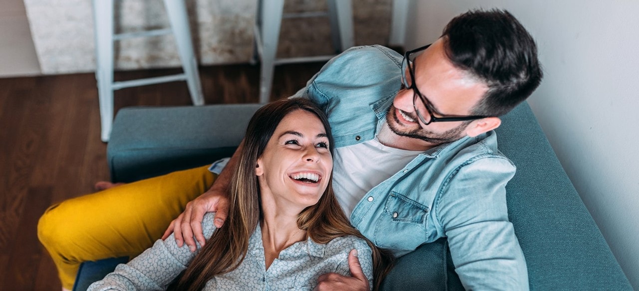 Happy couple sitting on couch