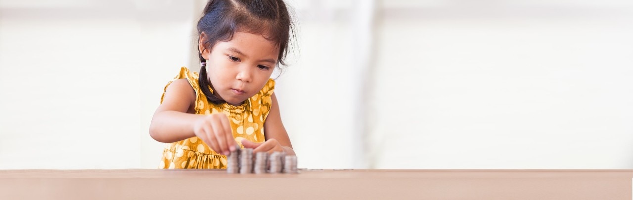 Young Asian girl stacking coins