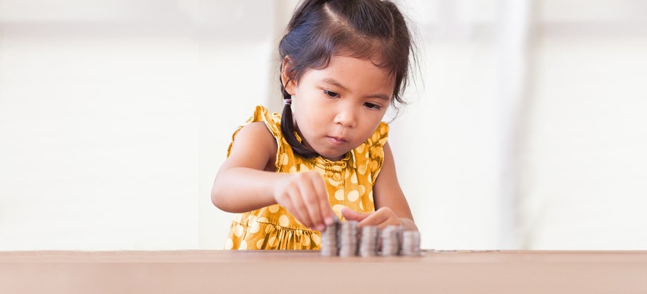 Young Asian girl stacking coins