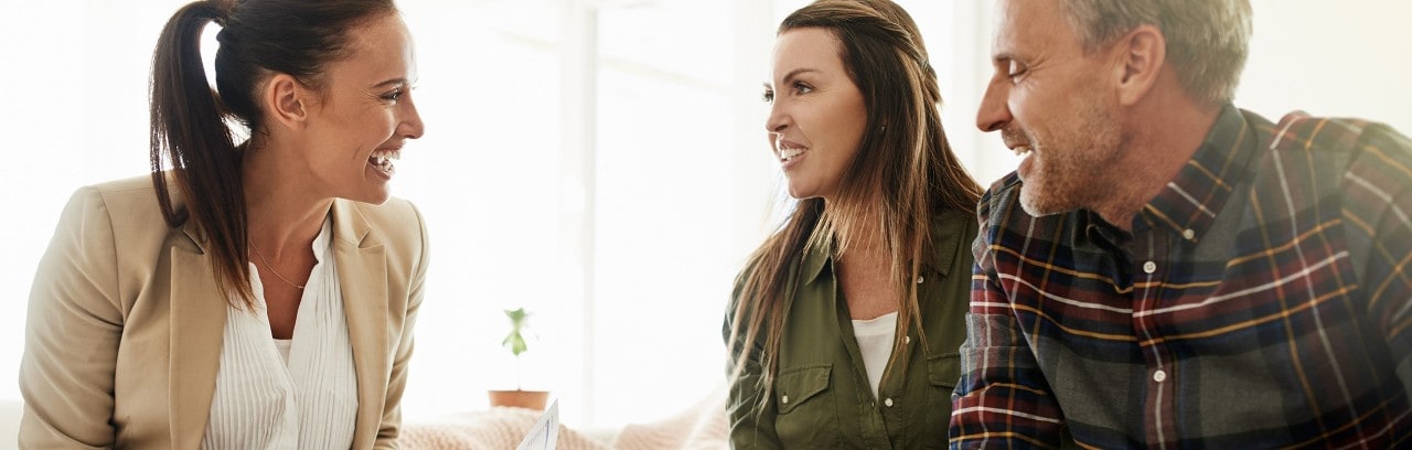 Couple reviewing documents with financial advisor