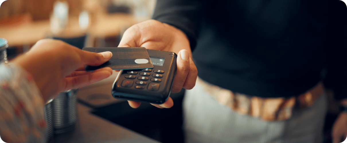 Credit card being used on a contactless payment device