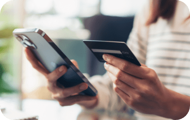 Woman's hands holding smartphone and credit card