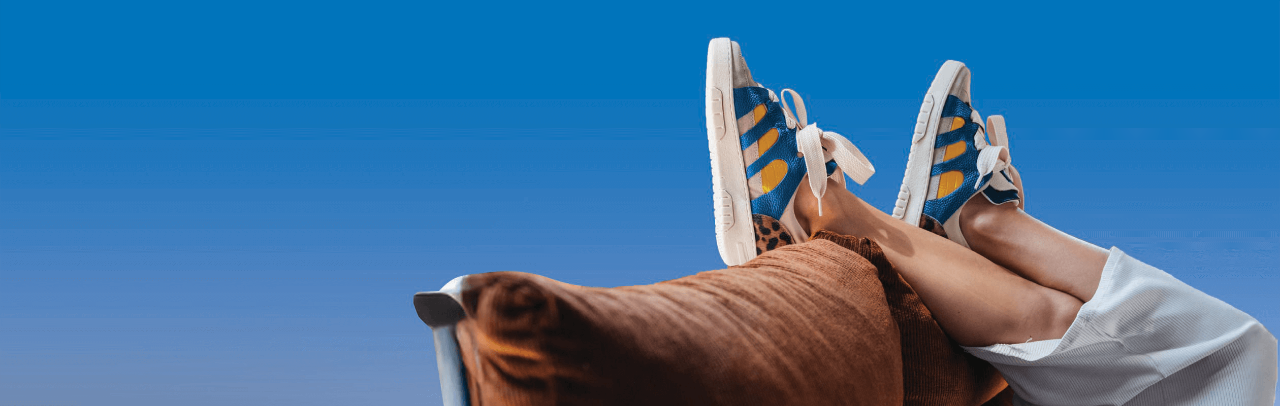 Feet resting on back of couch