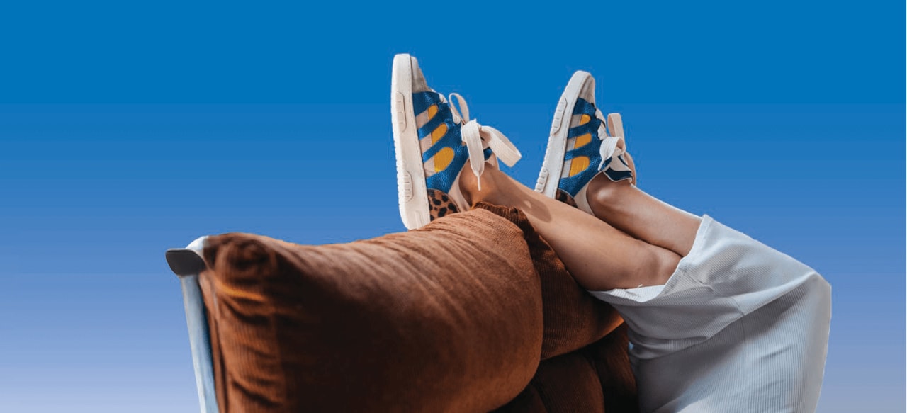 Feet resting on back of couch