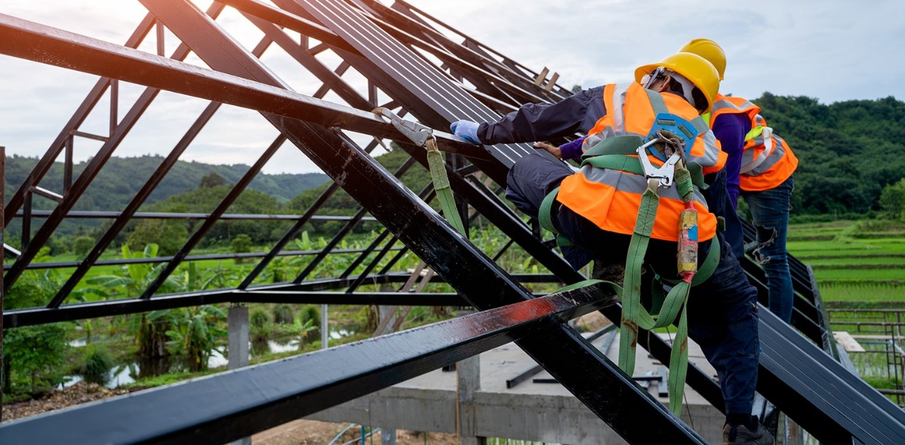 Builders constructing roof frame