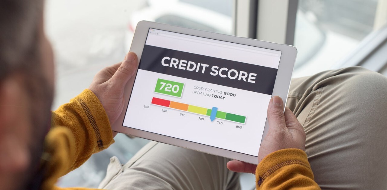 Man holding tablet looking at credit score