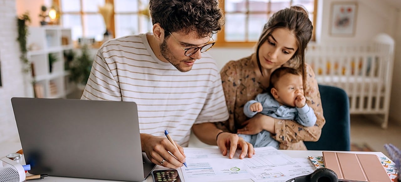 A man doing finances at a table with his family