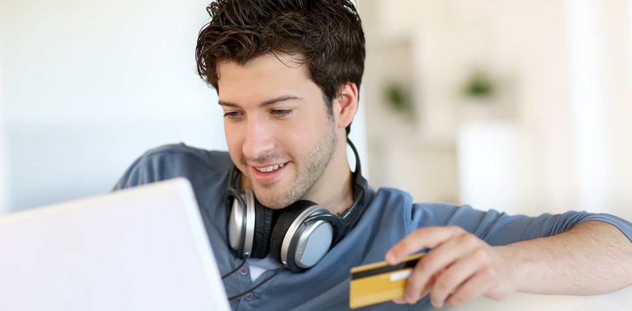 Young man shopping online with a credit card